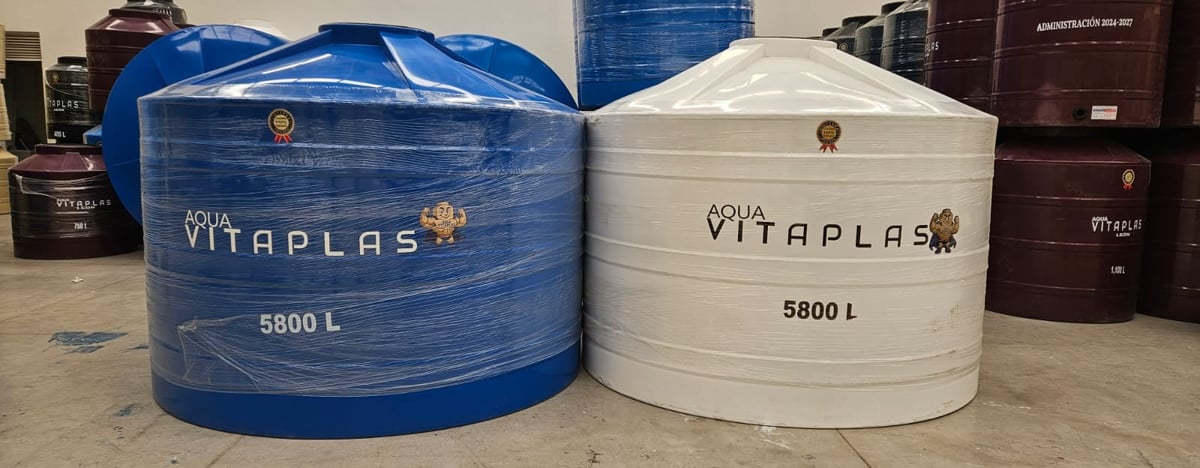 Two large VITAPLAS water storage tanks side by side - one blue and one white, each with 5800L capacity