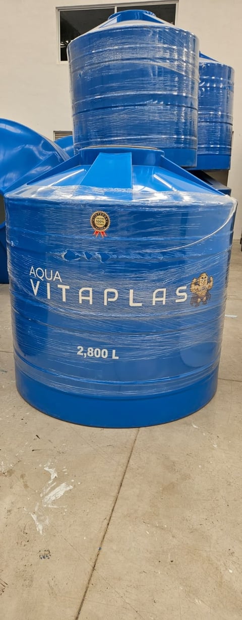 Blue Aqua Vitaplas water storage tanks with 2,800 liter capacity stacked outdoors on concrete floor