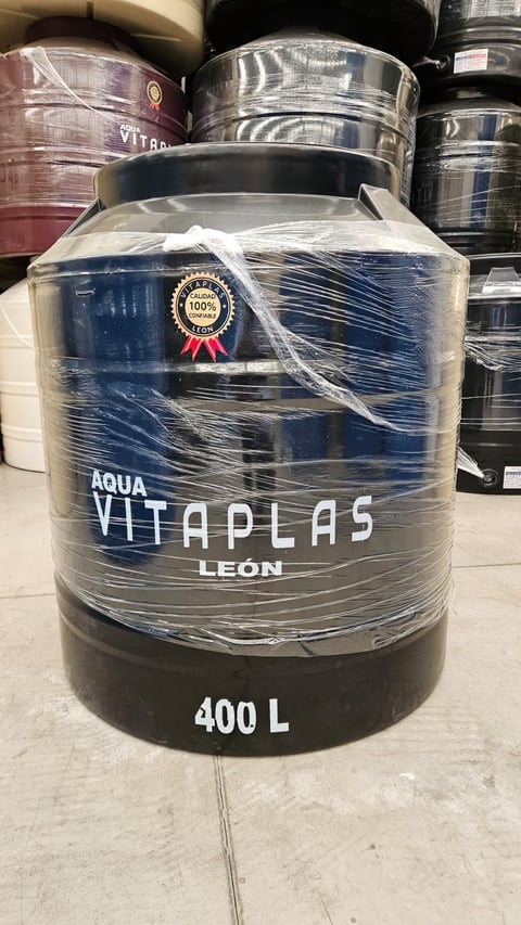 A 400-liter Aqua Vitaplas Leon water storage tank wrapped in plastic, displayed on a concrete floor with other tanks visible in the background